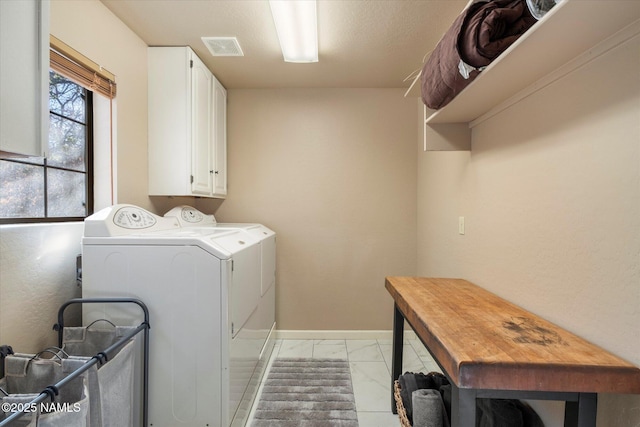 laundry area featuring cabinets and washer and clothes dryer