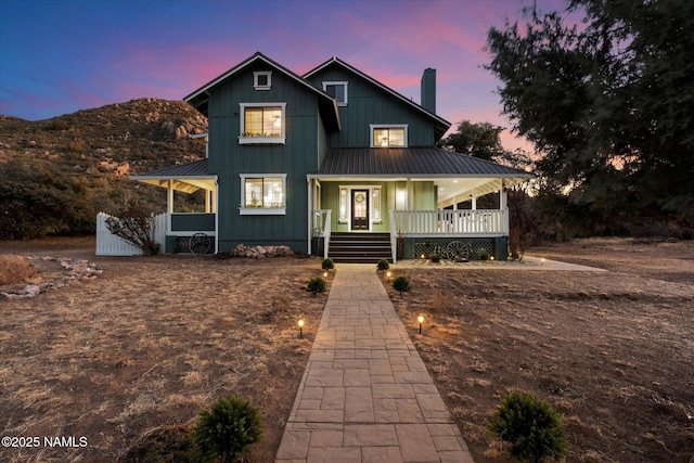 17441 W Fair Oaks Rd, Prescott, AZ 86305 - view of front facade with a chimney, metal roof, a standing seam roof, a porch, and board and batten siding