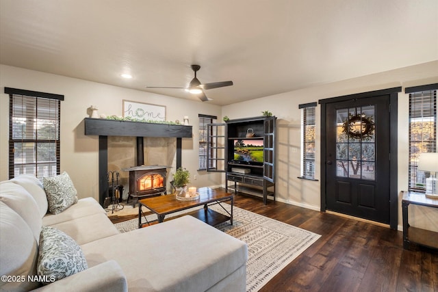 living room with dark wood-type flooring and ceiling fan