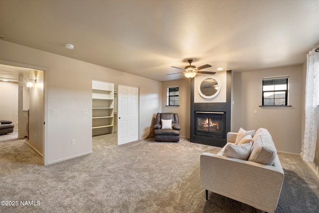 carpeted living room featuring ceiling fan