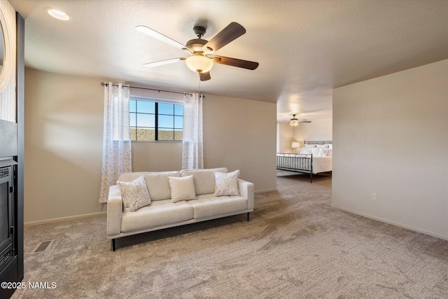 carpeted living room featuring ceiling fan