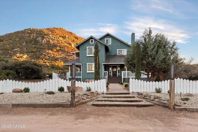 view of front of property with a porch and a mountain view