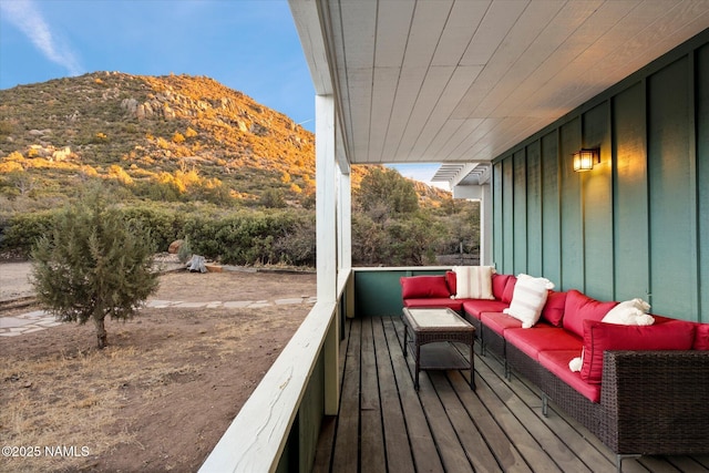 deck with a mountain view and outdoor lounge area