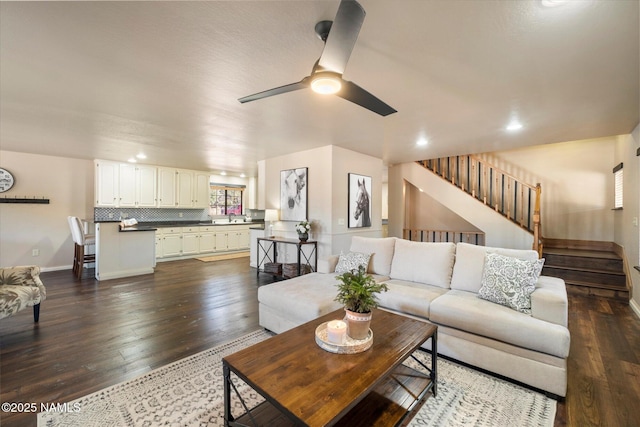 living room with dark hardwood / wood-style floors and ceiling fan