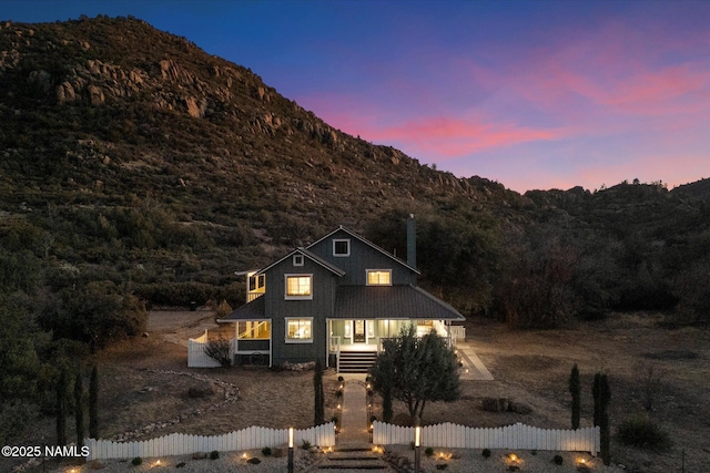 view of front property with a porch and a mountain view