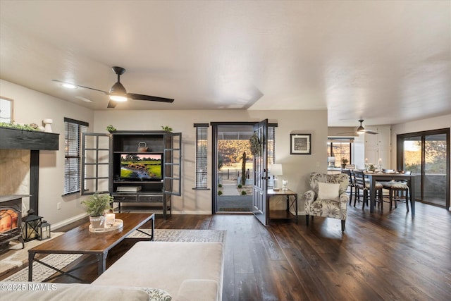 living room with dark wood-type flooring and ceiling fan