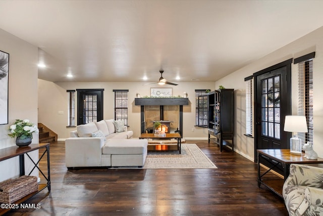 living room featuring ceiling fan and dark hardwood / wood-style flooring