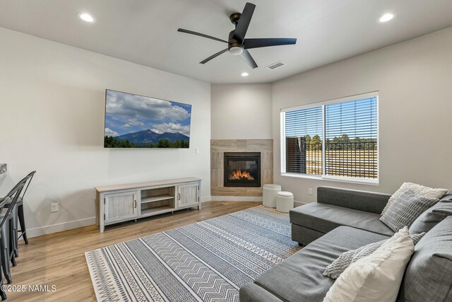 12220 Curtis Ct, Bellemont, AZ 86015 - living room featuring recessed lighting, a tiled fireplace, light wood-style floors, visible vents, and ceiling fan