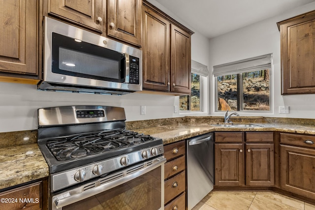 3330 Granite Rdg Lot 4, Flagstaff, AZ 86001 - kitchen featuring stainless steel appliances, a sink, light tile patterned flooring, and stone counters