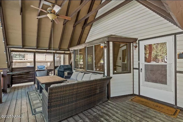 sunroom / solarium featuring ceiling fan and beam ceiling