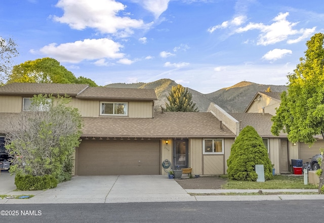 2550 E Cassidy Ln, Flagstaff, AZ 86004 - view of front facade with driveway, a shingled roof, a mountain view, and an attached garage
