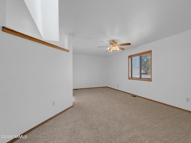 spare room featuring ceiling fan and carpet floors