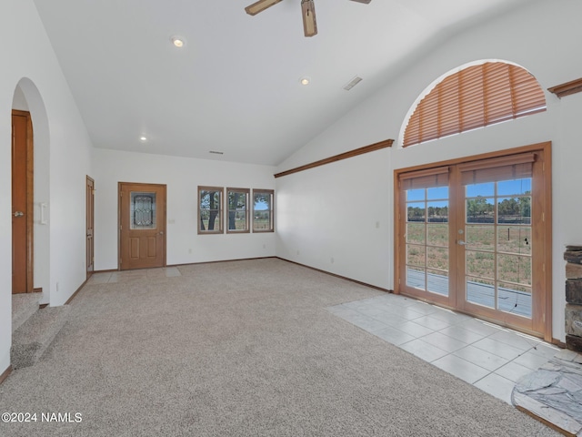 unfurnished living room featuring ceiling fan, high vaulted ceiling, and light colored carpet