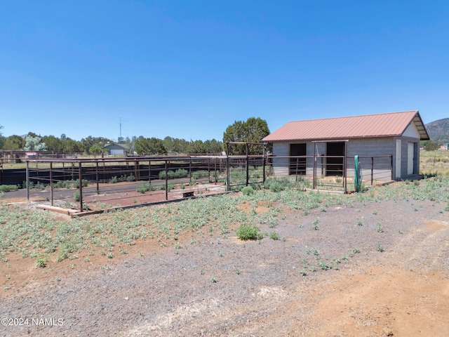 view of yard featuring an outbuilding and a rural view