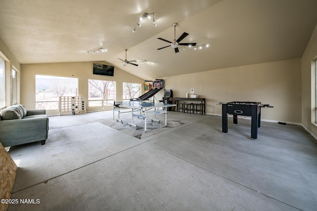 game room with ceiling fan, baseboards, and vaulted ceiling