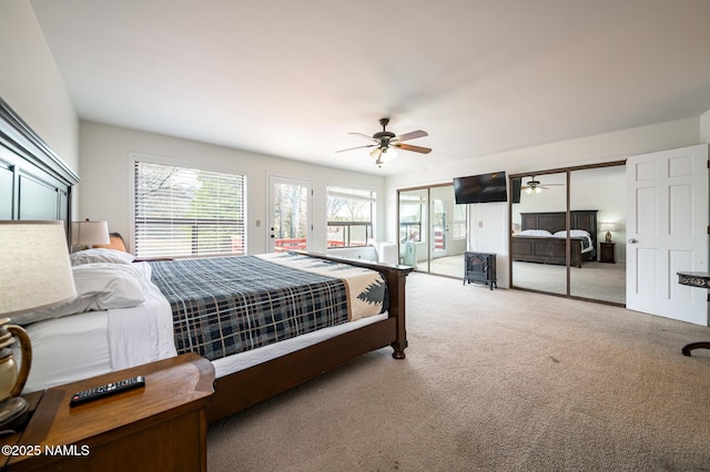 bedroom featuring two closets, access to exterior, a ceiling fan, and carpet floors