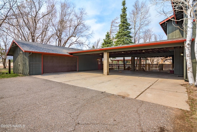 exterior space featuring an attached garage and aphalt driveway