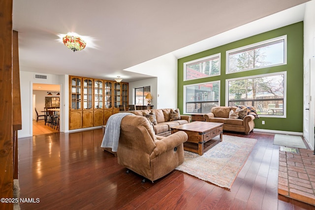 living area featuring dark wood-type flooring and visible vents