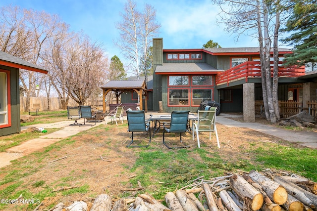 rear view of property with a gazebo and a patio