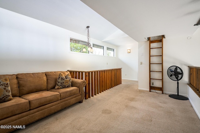 living area featuring baseboards, vaulted ceiling, and carpet floors