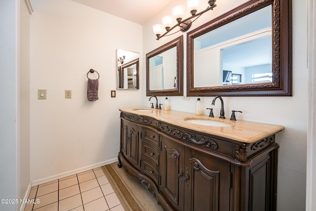 full bathroom featuring double vanity, a sink, tile patterned flooring, and baseboards