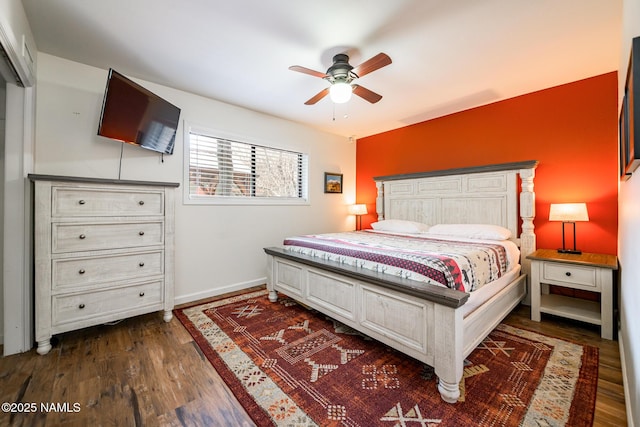 bedroom featuring baseboards, ceiling fan, and wood finished floors