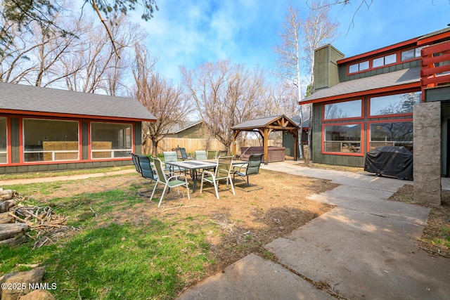 view of yard with a gazebo, a patio area, fence, and a hot tub