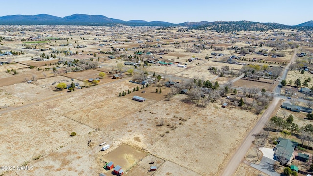 birds eye view of property featuring a rural view, a mountain view, and view of desert