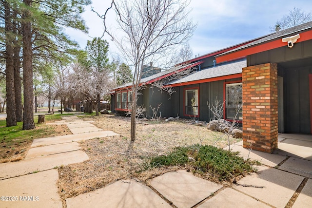 view of property exterior featuring roof with shingles