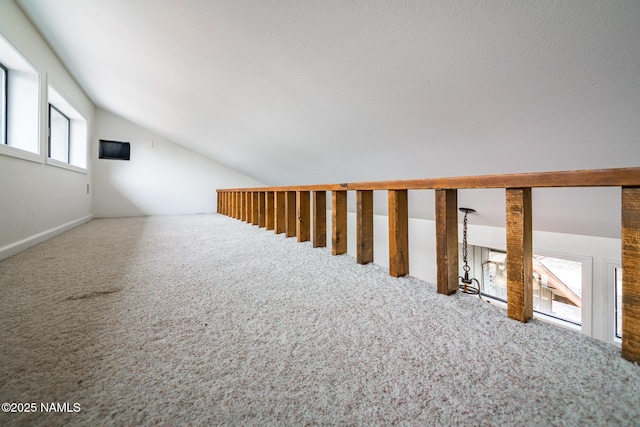 bonus room with carpet and lofted ceiling