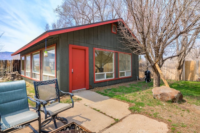 view of outbuilding featuring fence