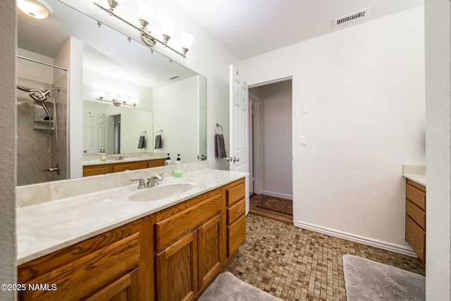 full bath with vanity, visible vents, and walk in shower