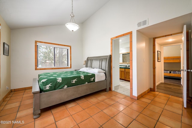 bedroom with high vaulted ceiling, ensuite bathroom, visible vents, light tile patterned flooring, and baseboards
