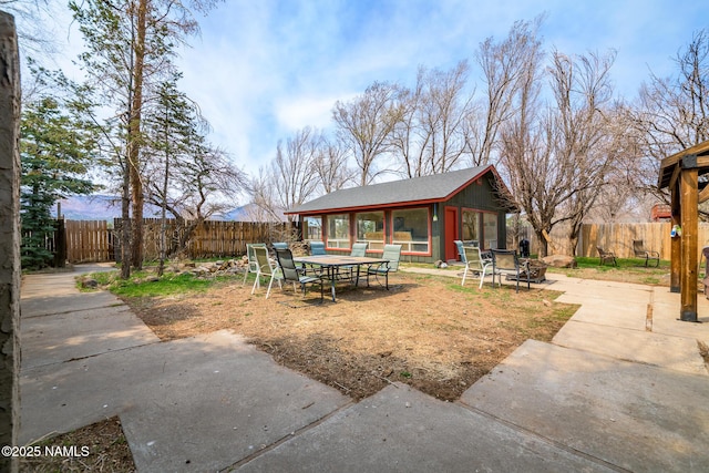 view of patio / terrace with an outbuilding and a fenced backyard