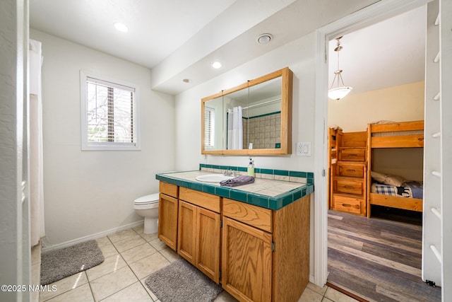 full bath with baseboards, toilet, recessed lighting, vanity, and tile patterned floors