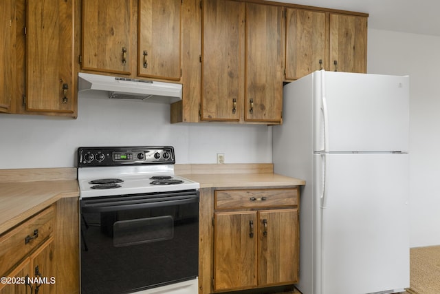 5920 Wildflower Rd, Flagstaff, AZ 86004 - kitchen featuring light countertops, under cabinet range hood, range with electric stovetop, freestanding refrigerator, and brown cabinetry
