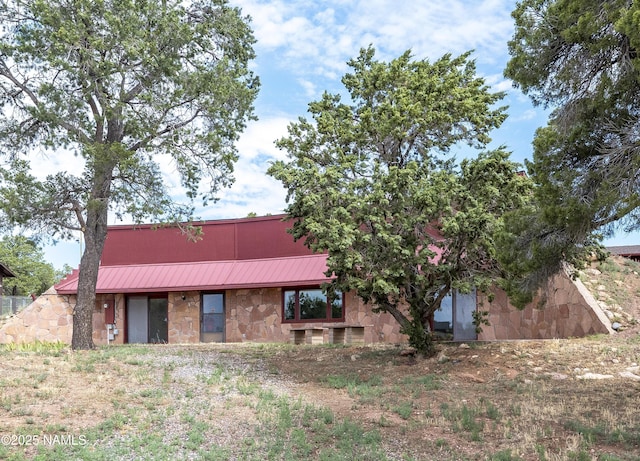 5920 Wildflower Rd, Flagstaff, AZ 86004 - exterior space featuring stone siding, a standing seam roof, and metal roof