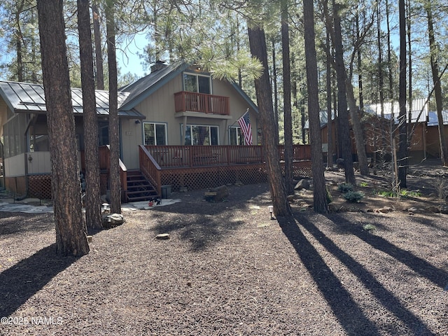 2511 Black Bear Ln, Pine Top, AZ 85935 - rear view of property featuring a balcony, a chimney, metal roof, a standing seam roof, and a deck