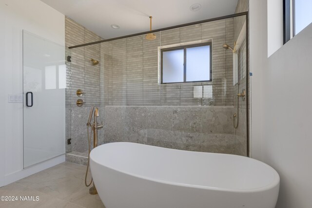 bathroom featuring independent shower and bath and tile patterned floors