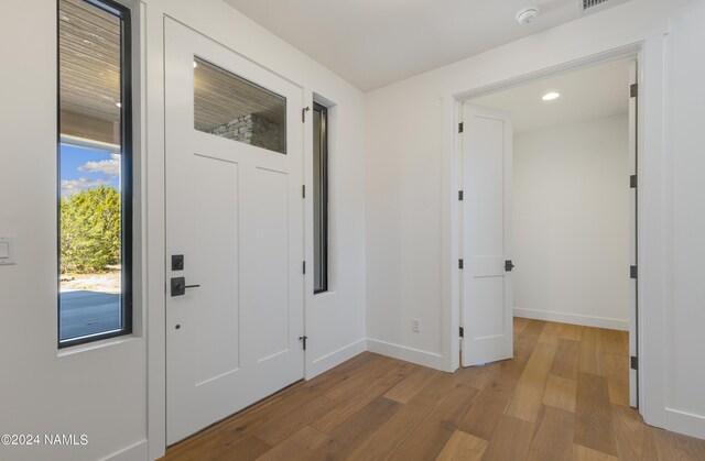 entryway with hardwood / wood-style floors