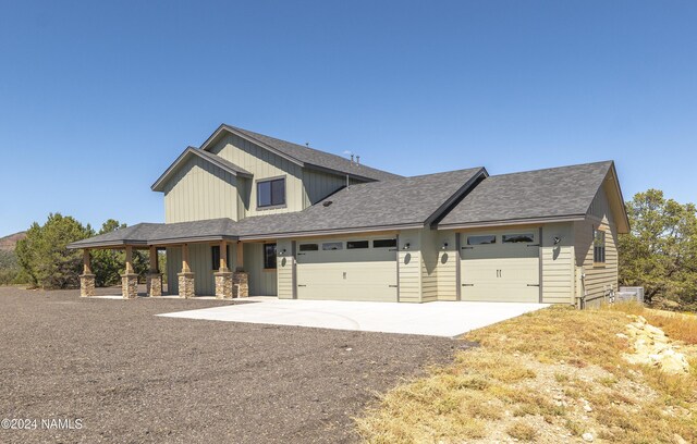 craftsman inspired home featuring a porch and a garage