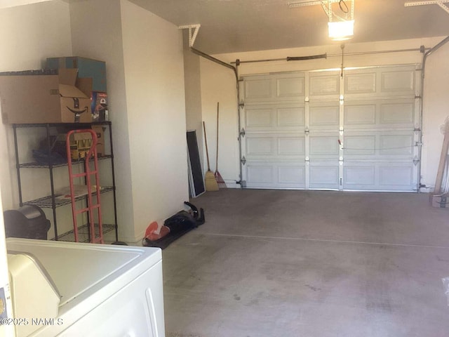 garage with washer / dryer and a garage door opener