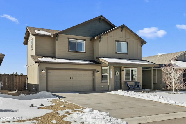 view of front of house featuring an attached garage, fence, board and batten siding, and concrete driveway