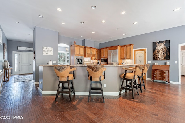 1533 S Minstrel Ln, Williams, AZ 86046 - kitchen featuring stainless steel appliances, a peninsula, a breakfast bar area, light stone countertops, and recessed lighting