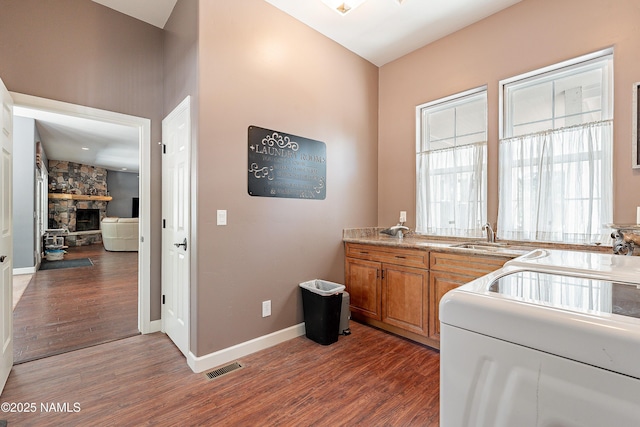 1533 S Minstrel Ln, Williams, AZ 86046 - laundry area featuring wood finished floors and a fireplace