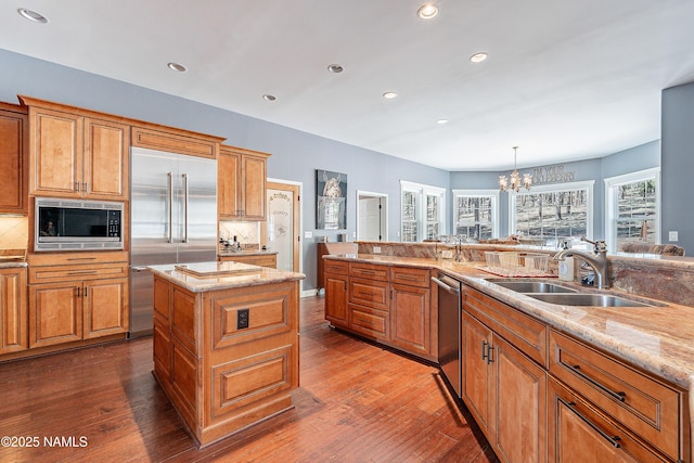 1533 S Minstrel Ln, Williams, AZ 86046 - kitchen with built in appliances, a chandelier, wood finished floors, a kitchen island, and recessed lighting