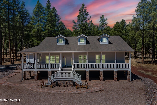 1533 S Minstrel Ln, Williams, AZ 86046 - view of front of house with covered porch, stone siding, stairway, and roof with shingles
