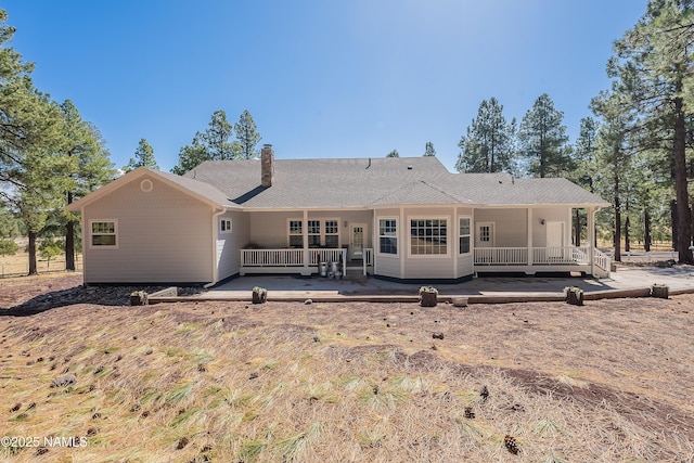 1533 S Minstrel Ln, Williams, AZ 86046 - back of house featuring a chimney and covered porch