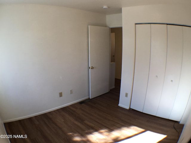 2157 E Arroyo Seco Dr, Flagstaff, AZ 86004 - unfurnished bedroom featuring dark hardwood / wood-style flooring and a closet