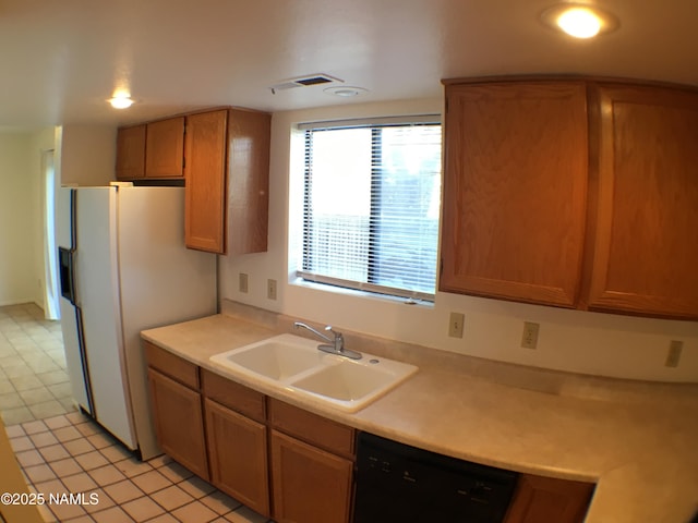 2157 E Arroyo Seco Dr, Flagstaff, AZ 86004 - kitchen with black dishwasher, sink, and white fridge with ice dispenser